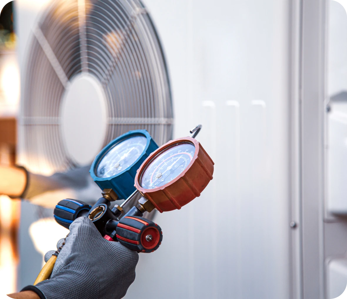 Technician checking air conditioning unit gauges.
